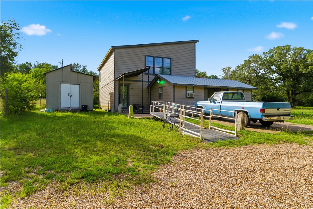 211 Webberwood Way Elgin, TX 78621 - Photo 10 of 10 A well-maintained residence with a private yard and practical outbuilding.
