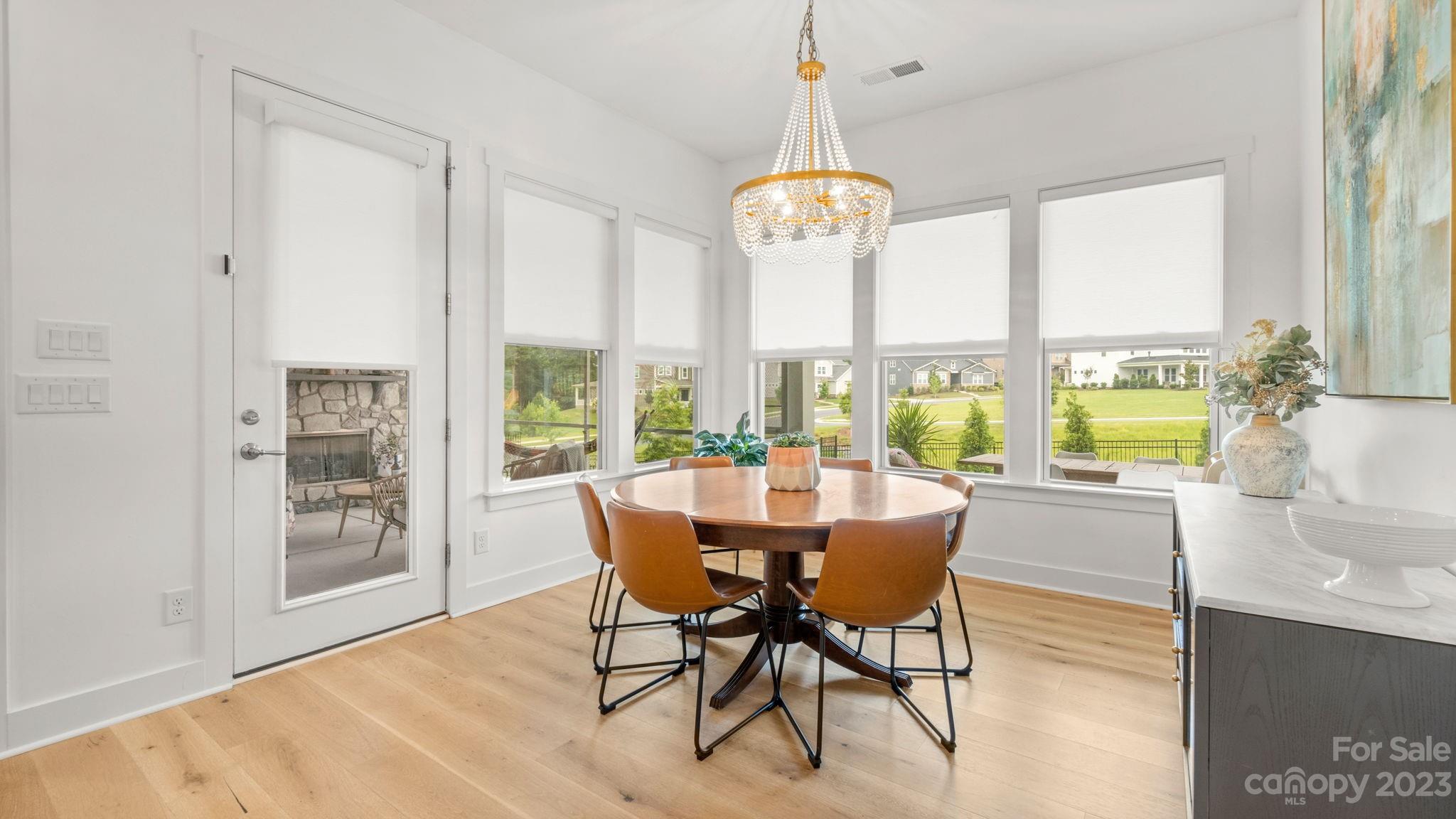 1111 Therns Ferry Drive Fort Mill, SC 29708 - Photo 15 of 39 a view of a dining room with furniture a chandelier and wooden floor