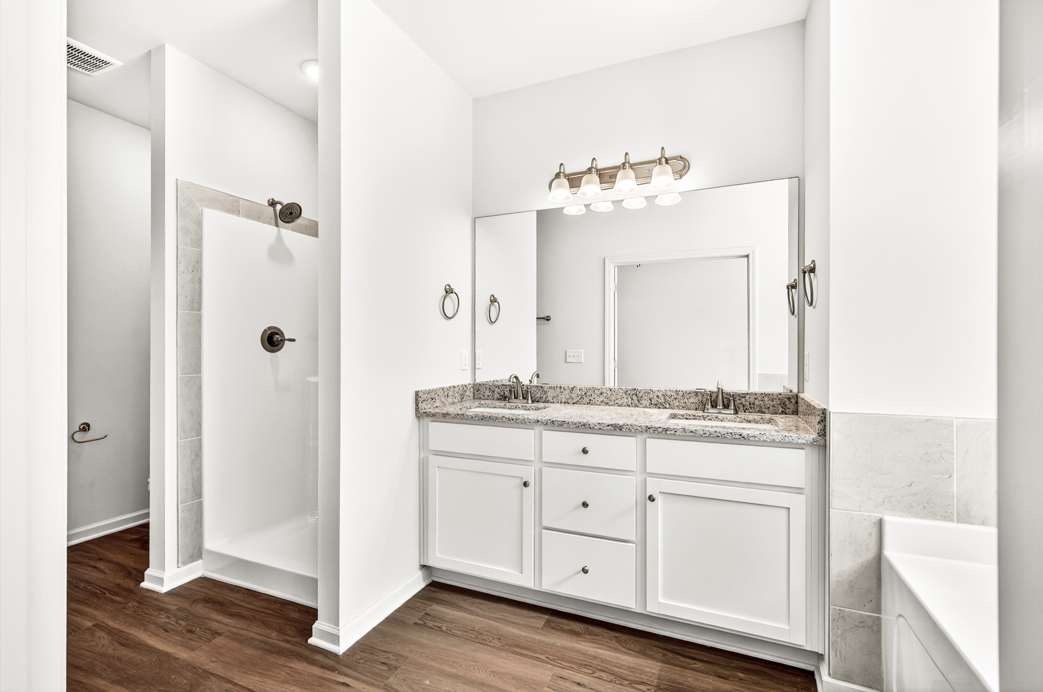 7107 Wiley Circle Fairview, TN 37062 - Photo 15 of 27 a bathroom with a granite countertop sink a mirror and a shower
