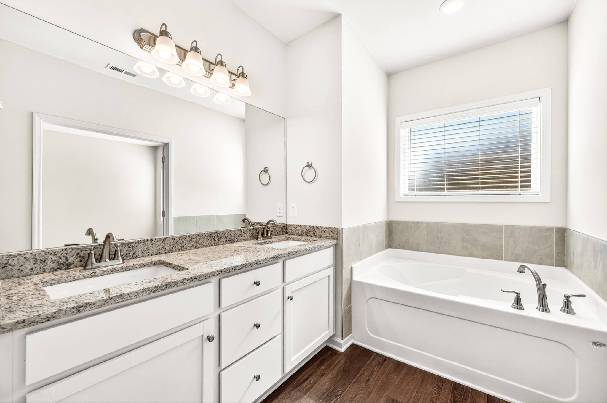 7107 Wiley Circle Fairview, TN 37062 - Photo 16 of 27 a bathroom with a granite countertop tub a double vanity sink and mirror