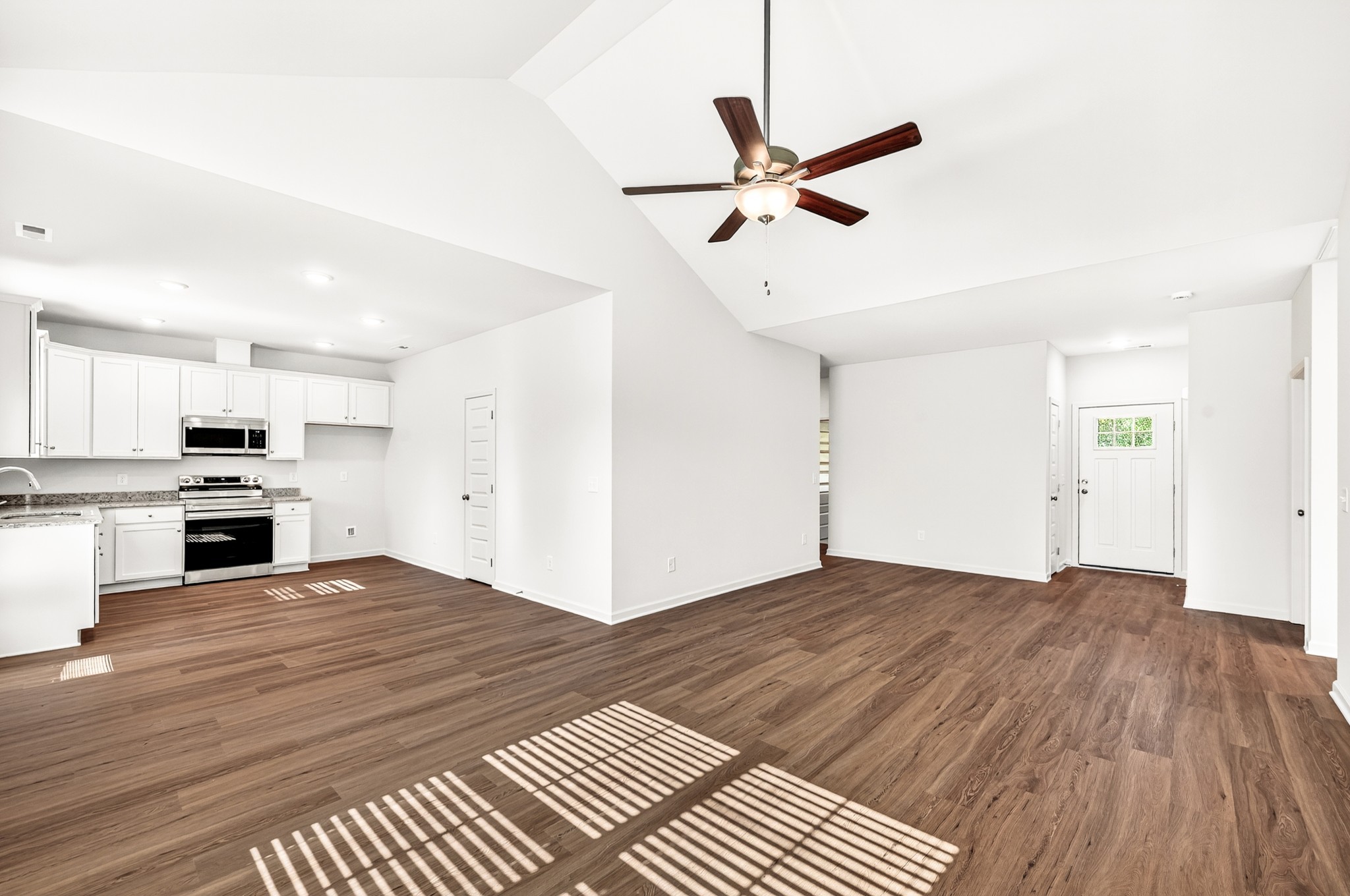 7107 Wiley Circle Fairview, TN 37062 - Photo 7 of 27 a view of empty room with wooden floor and kitchen view
