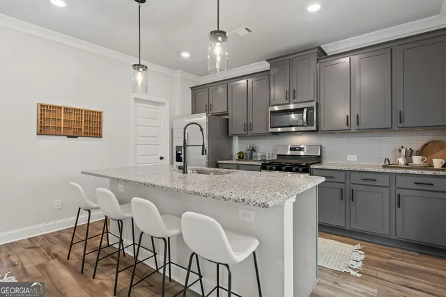 a kitchen with center island table and chairs in it