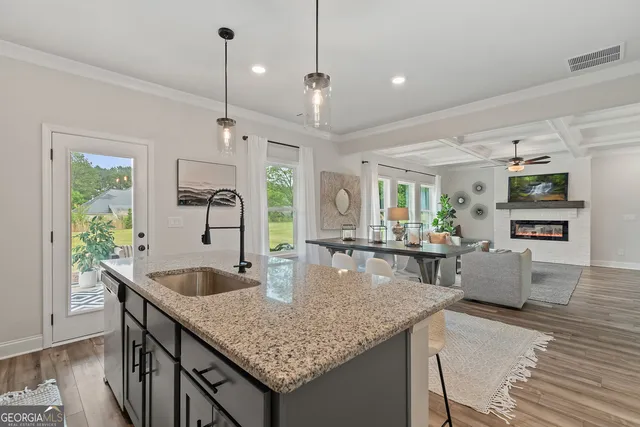 a view of a dining room with furniture a chandelier and wooden floor