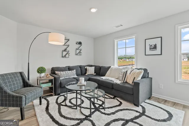 a bed room with a bed and a chair