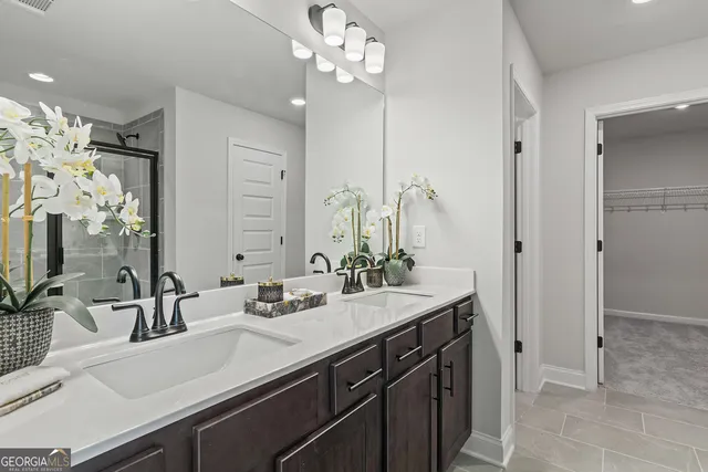 a bedroom with a bed a mirror and windows