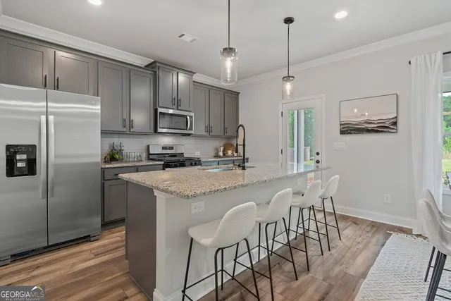 a dining room with kitchen island a table and chairs
