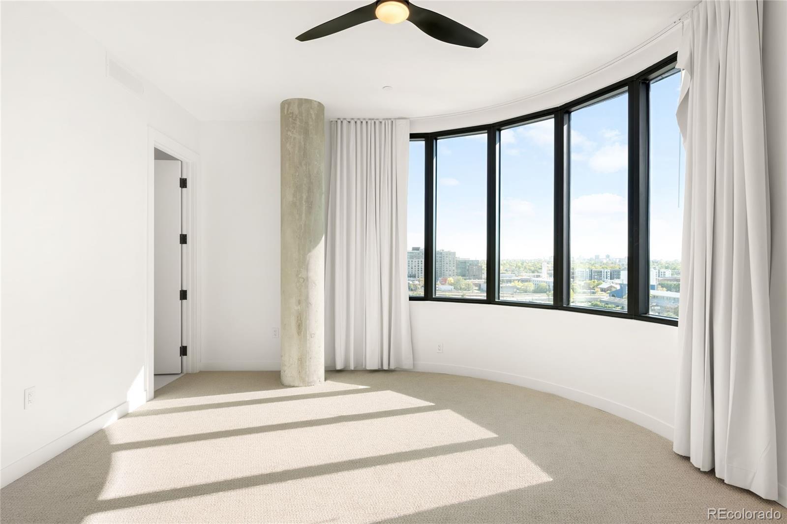 3520 Chestnut Place, Unit 1110 Denver, CO 80216 - Photo 13 of 39 a view of an empty room with a window