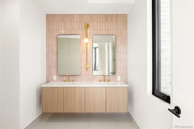 a bathroom with a double vanity sink and a mirror