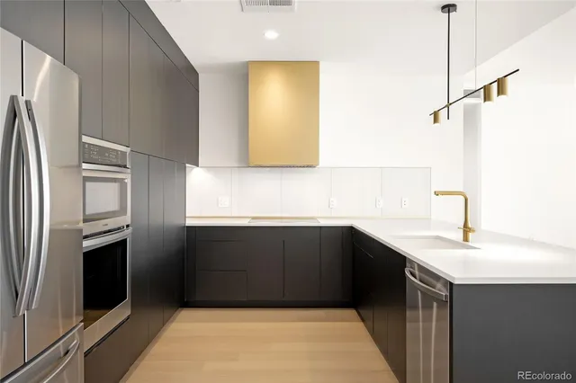 a kitchen with a sink refrigerator and microwave