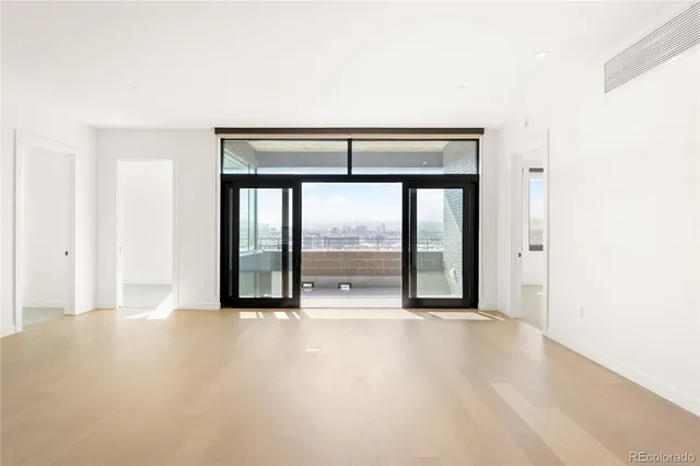 an empty room with large windows