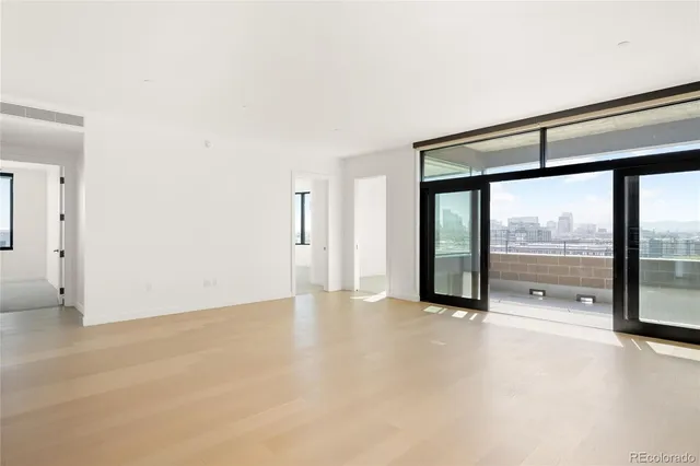 an empty room with sliding glass door and shower