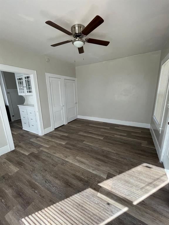 516 South Nueces Street Coleman, TX 76834 - Photo 12 of 20 a view of a livingroom with wooden floor and white walls