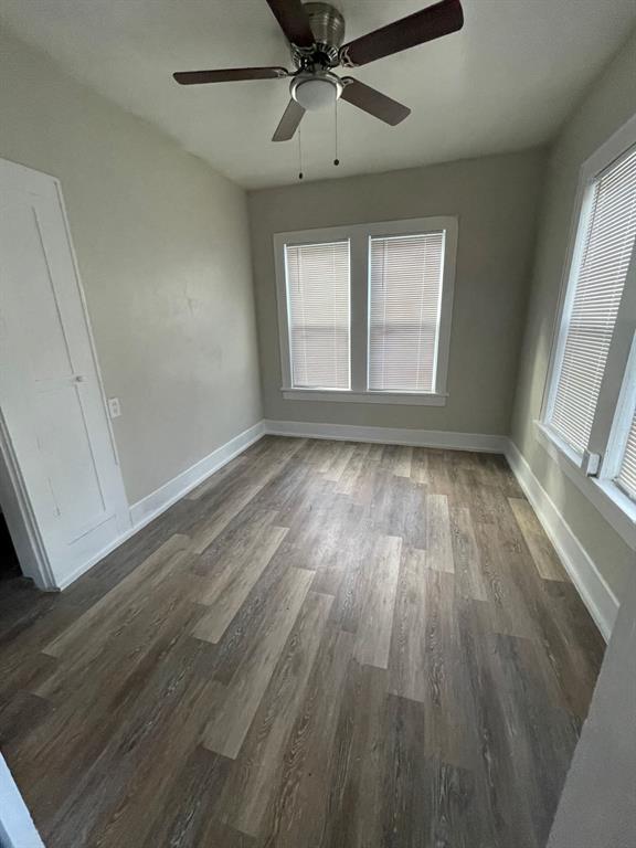 516 South Nueces Street Coleman, TX 76834 - Photo 14 of 20 wooden floor in an empty room with a window