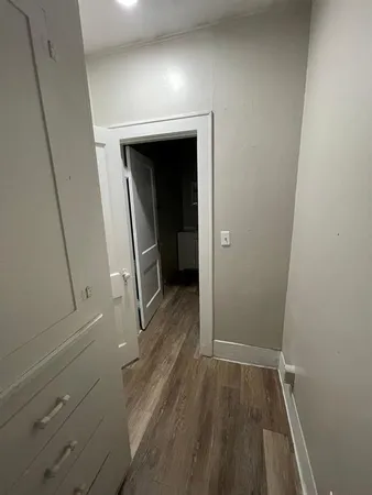a view of walk in closet with wooden floor