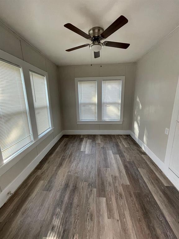 516 South Nueces Street Coleman, TX 76834 - Photo 4 of 20 wooden floor in an empty room with a window