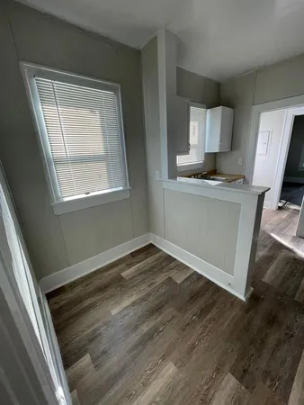 a view of kitchen with wooden floor and electronic appliances