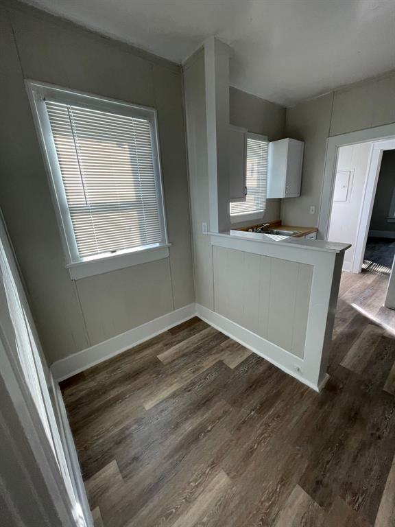 516 South Nueces Street Coleman, TX 76834 - Photo 9 of 20 a view of kitchen with wooden floor and electronic appliances