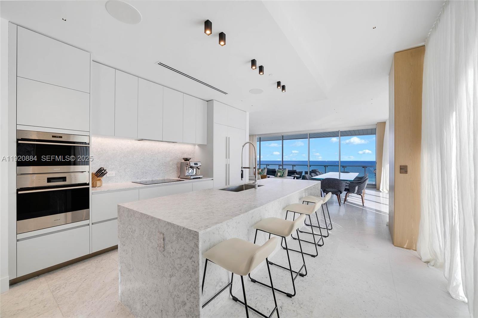 5775 Collins Avenue, Unit 1501 Miami Beach, FL 33140 - Photo 17 of 77 a view of kitchen with cabinets and wooden floor
