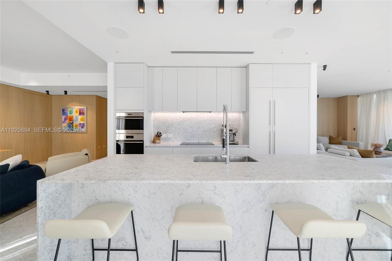 5775 Collins Avenue, Unit 1501 Miami Beach, FL 33140 - Photo 21 of 77 a kitchen with stainless steel appliances kitchen island granite countertop a sink and cabinets