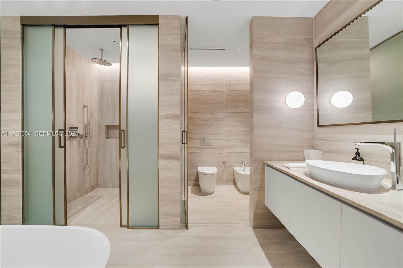 5775 Collins Avenue, Unit 1501 Miami Beach, FL 33140 - Photo 29 of 77 a bathroom with a sink a toilet and shower