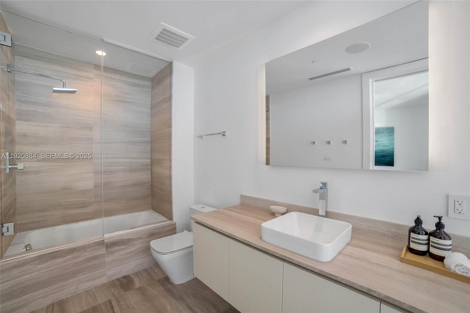 5775 Collins Avenue, Unit 1501 Miami Beach, FL 33140 - Photo 41 of 77 a bathroom with a sink a toilet and shower