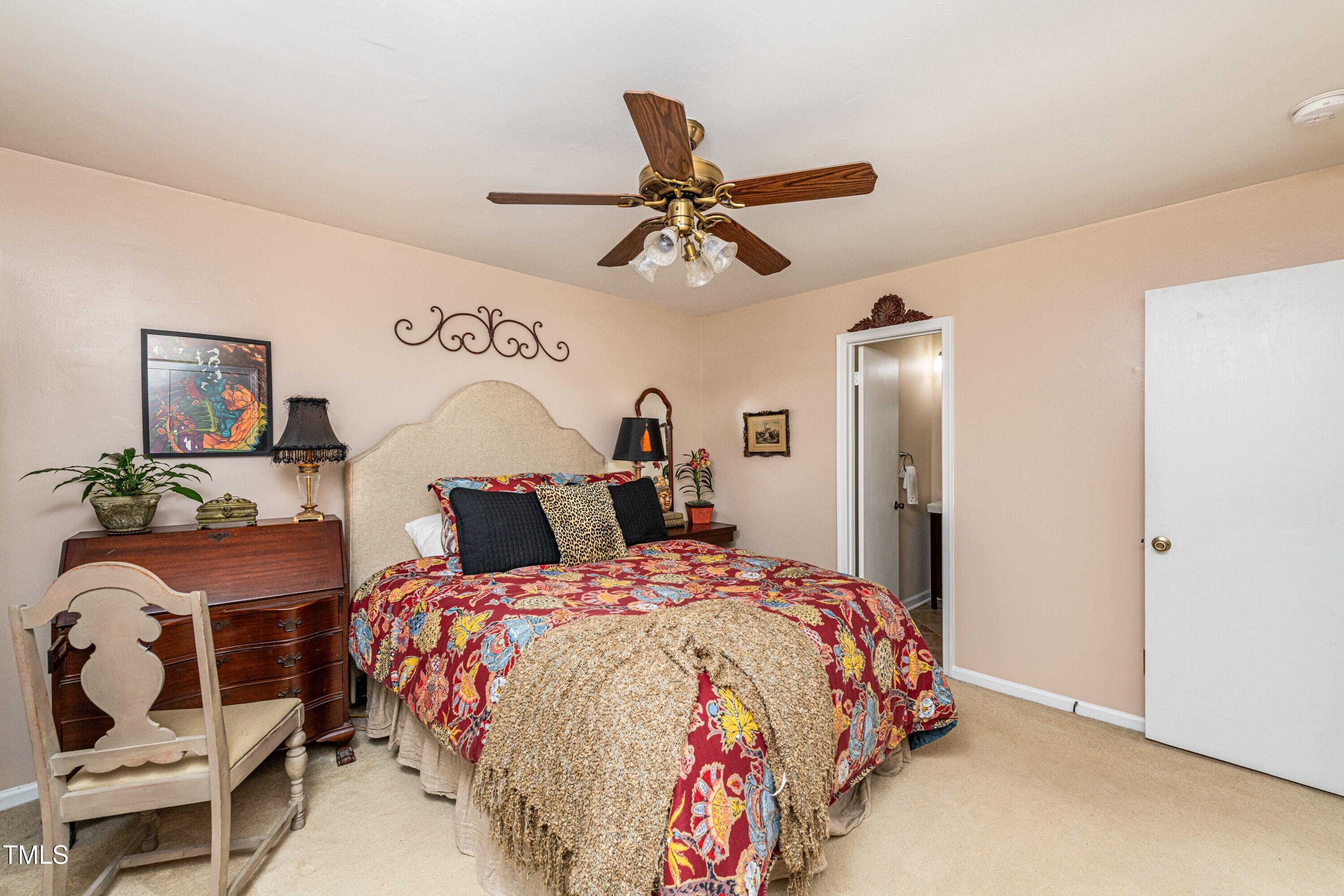1008 Mockingbird Drive Raleigh, NC 27615 - Photo 19 of 32 a bedroom with a bed a chandelier fan and a window