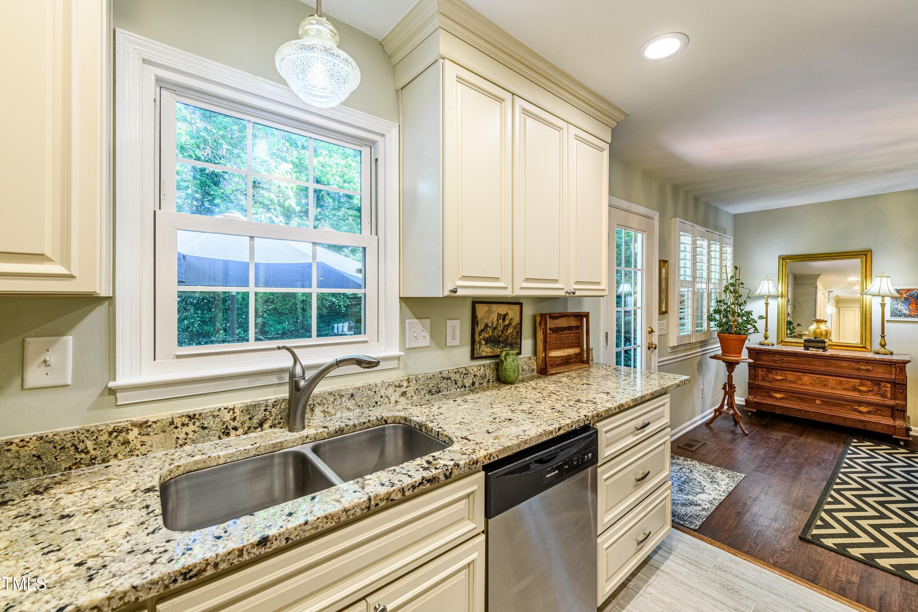 1008 Mockingbird Drive Raleigh, NC 27615 - Photo 7 of 32 a kitchen with a stove a sink and a granite counter tops