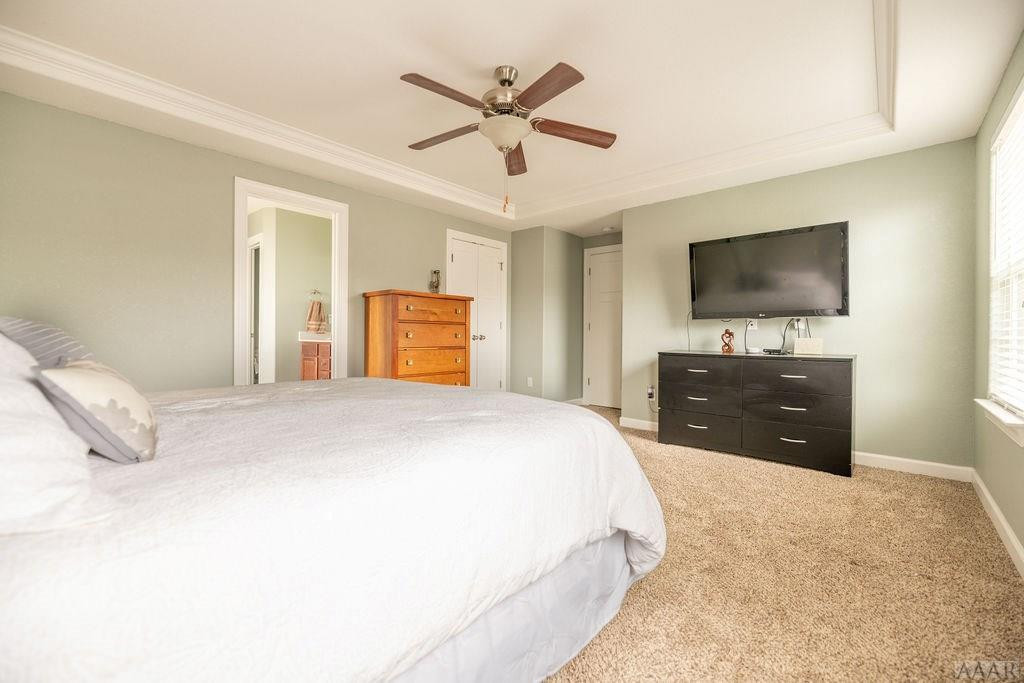 107 Rosedale Court Moyock, NC 27958 - Photo 16 of 31 A tray ceiling and fan highlight the Master