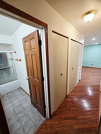 an empty room with wooden floor and furniture