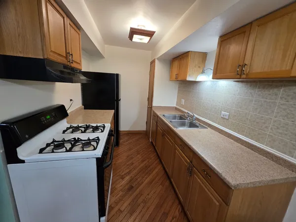 a kitchen with stainless steel appliances a stove a sink and a microwave