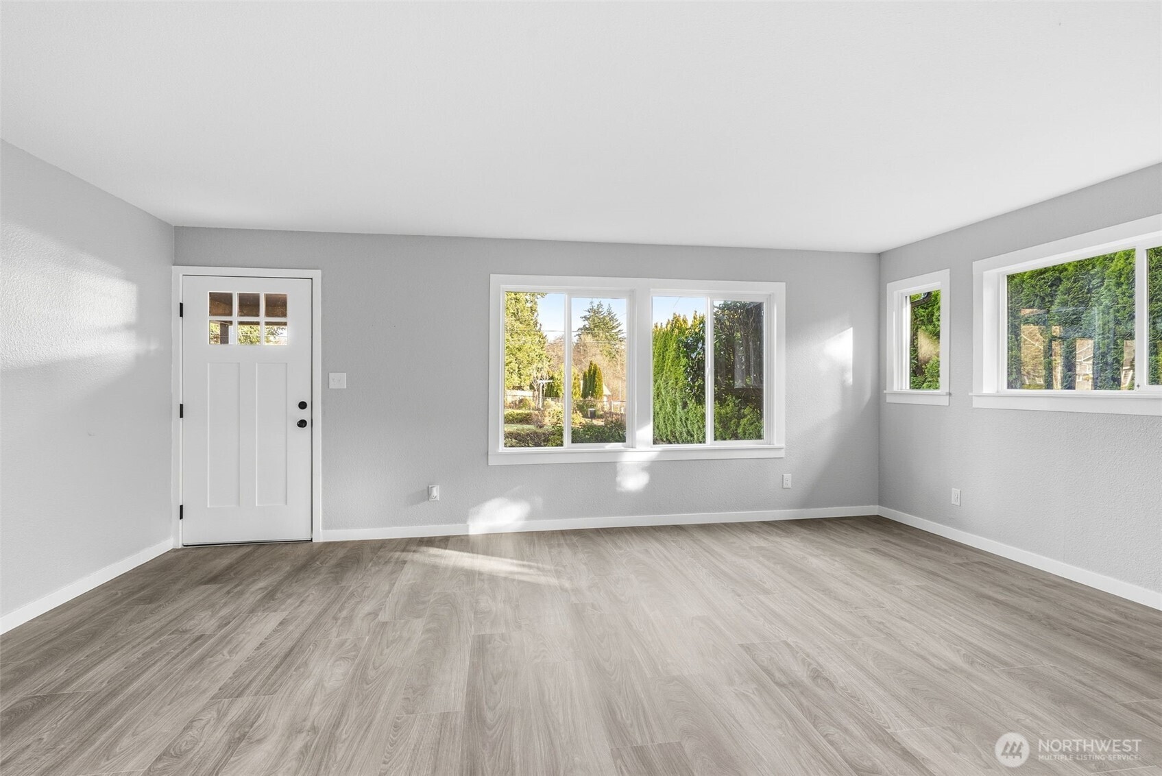 508 Nevada Drive Longview, WA 98632 - Photo 14 of 29 an empty room with wooden floor and windows