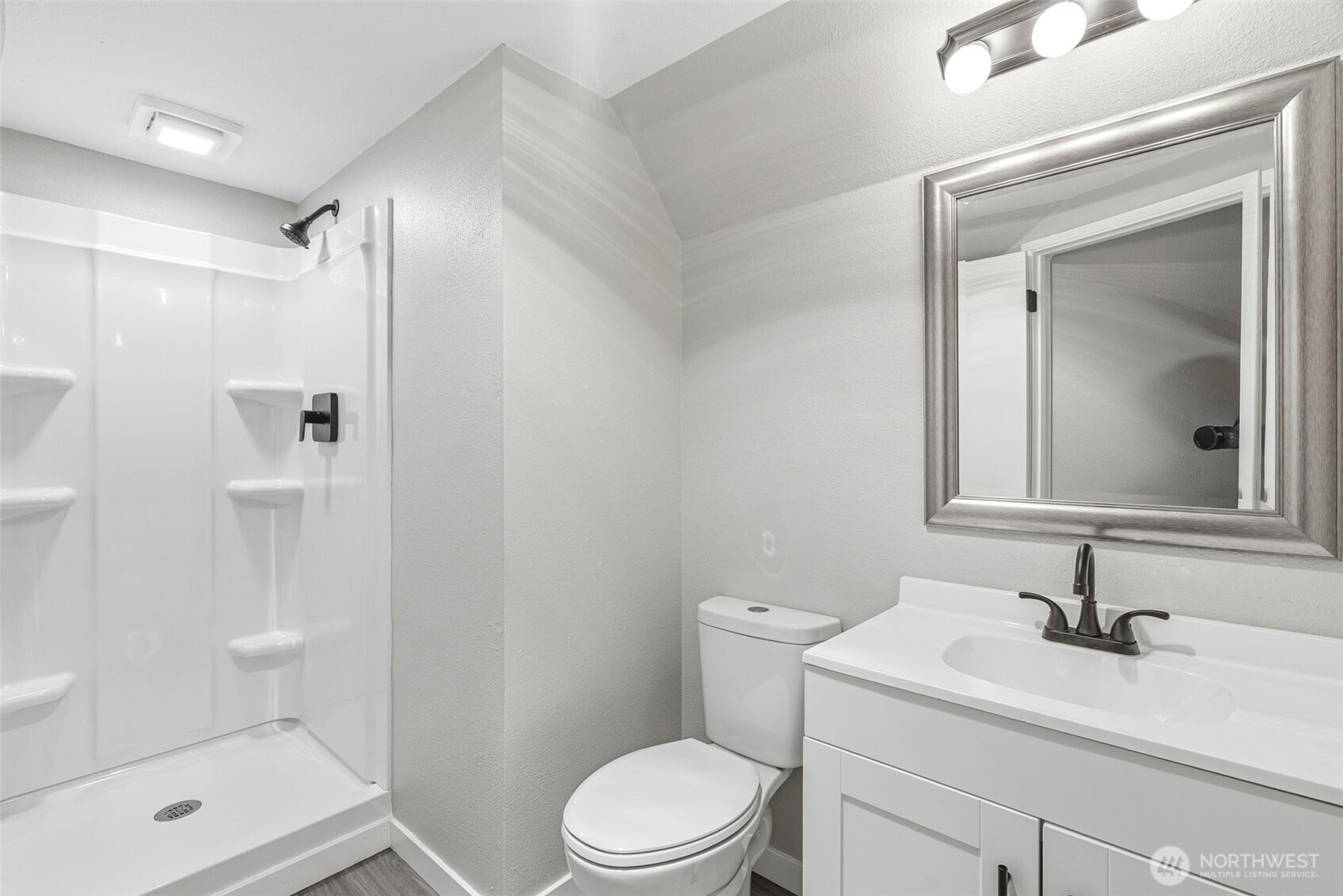 508 Nevada Drive Longview, WA 98632 - Photo 18 of 29 a bathroom with a granite countertop sink toilet a mirror and shower