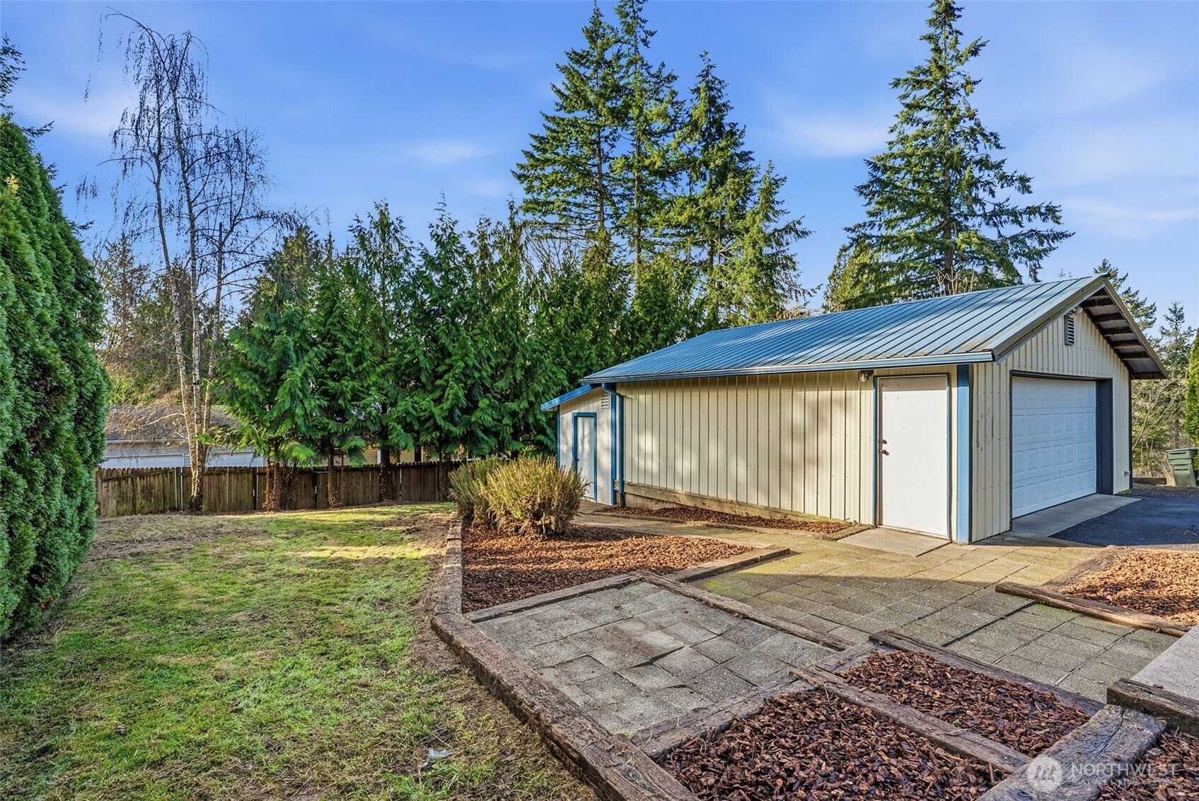 508 Nevada Drive Longview, WA 98632 - Photo 25 of 29 a backyard of a house with large trees and wooden fence