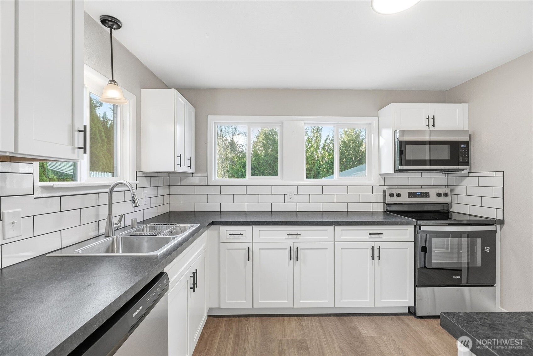 508 Nevada Drive Longview, WA 98632 - Photo 8 of 29 a kitchen with stainless steel appliances granite countertop a sink a stove and a wooden floors