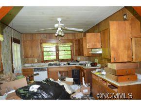 131 Osborne Ridge Road Canton, NC 28716 - Photo 3 of 11 a open kitchen with kitchen island granite countertop a sink cabinets and window