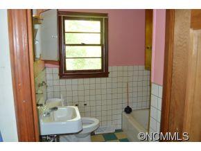 131 Osborne Ridge Road Canton, NC 28716 - Photo 5 of 11 a bathroom with a sink a mirror and a shower