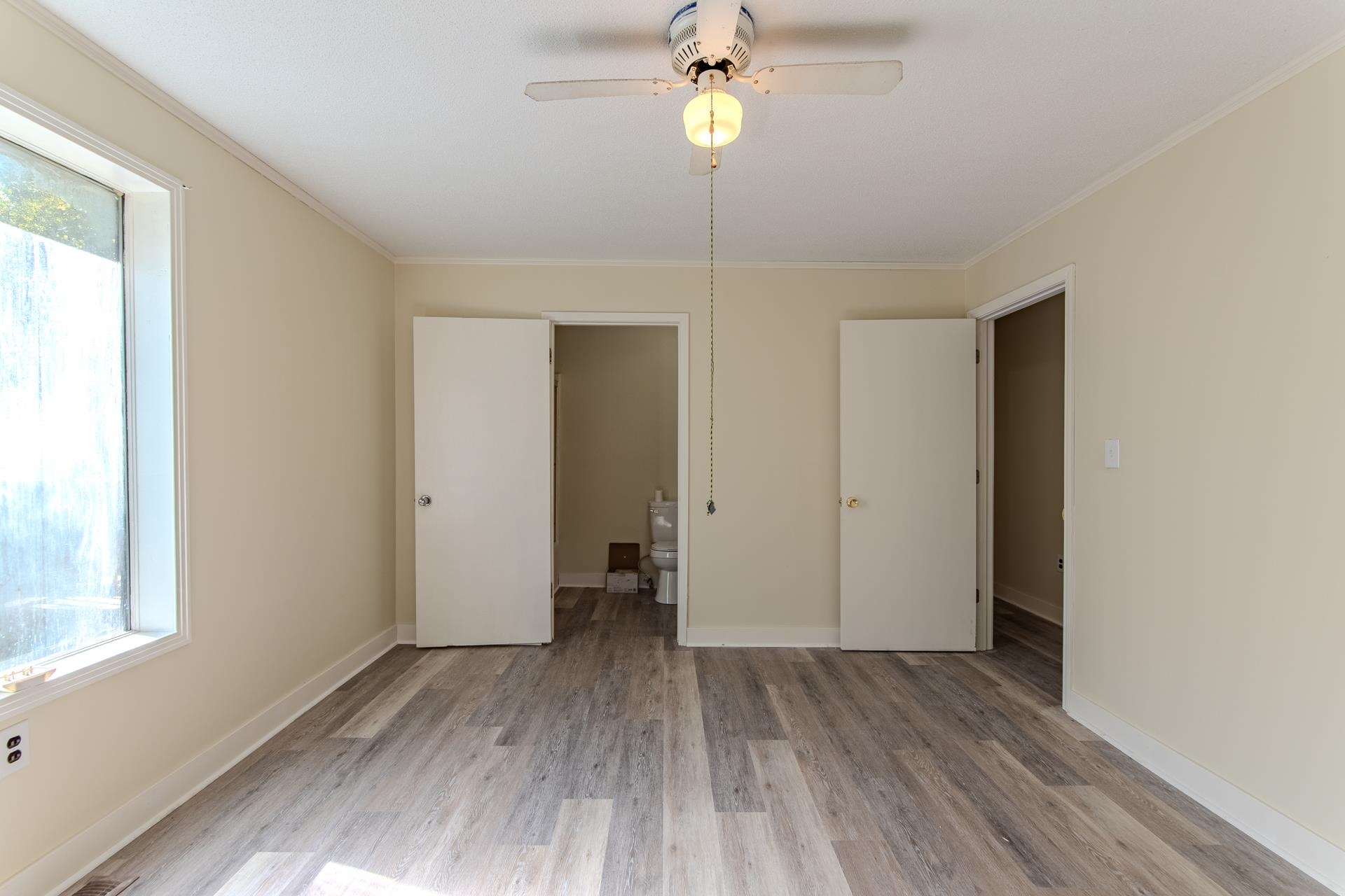 35 Trail Lane Savannah, TN 38372 - Photo 17 of 39 a view of an empty room with a window and wooden floor