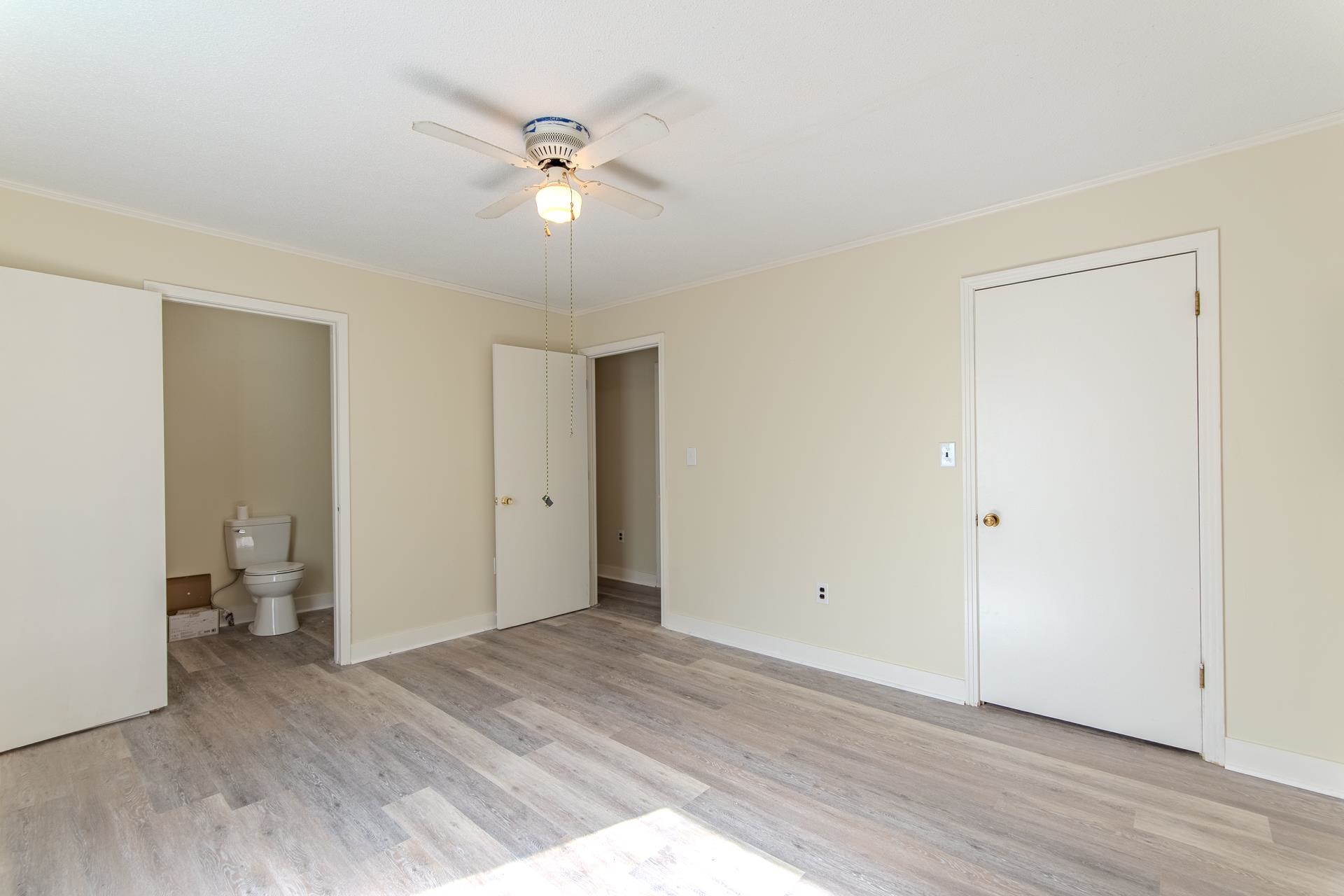 35 Trail Lane Savannah, TN 38372 - Photo 18 of 39 a view of an empty room with wooden floor and a ceiling fan