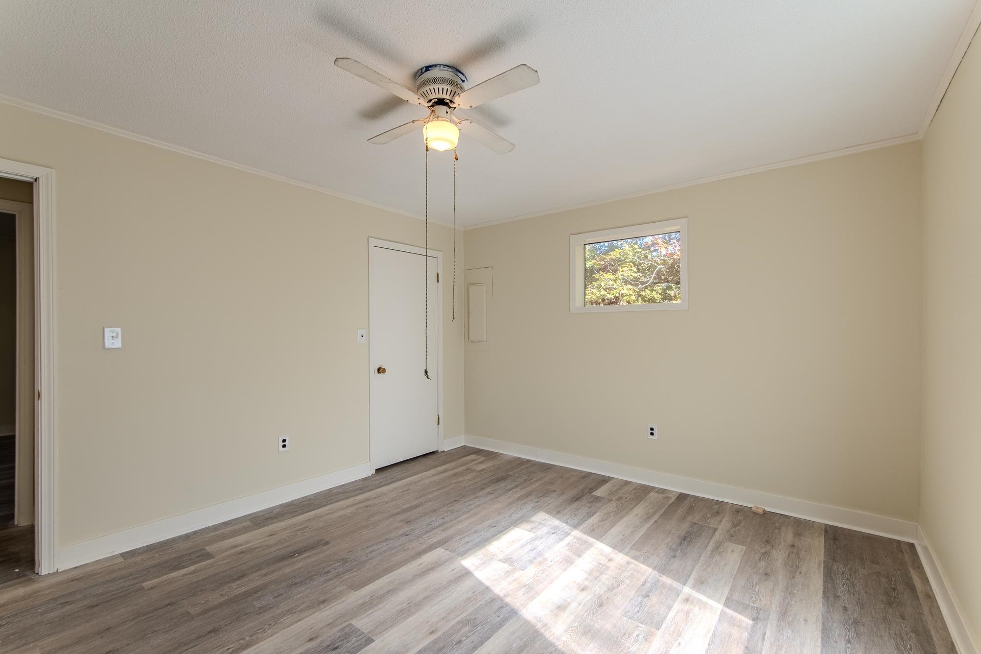 35 Trail Lane Savannah, TN 38372 - Photo 20 of 39 an empty room with wooden floor and window