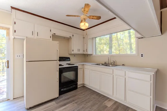 a kitchen with white cabinets and white appliances