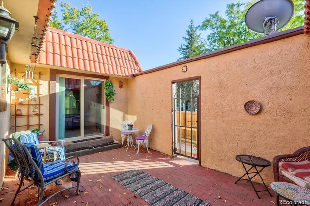 a patio with a table and chairs