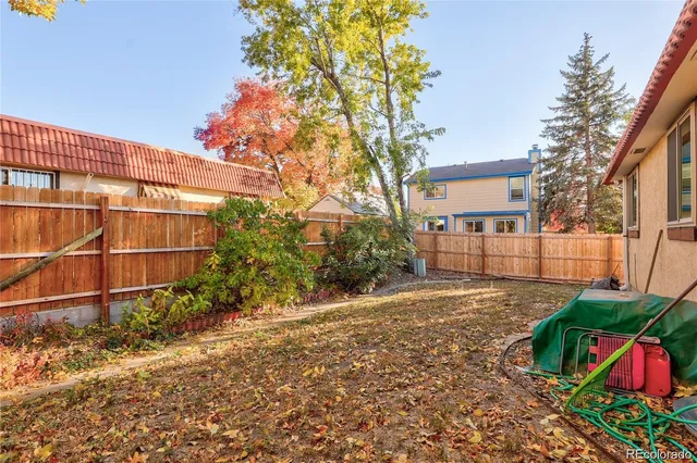 a view of a backyard with large trees