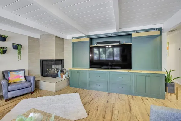 a kitchen with stainless steel appliances kitchen island granite countertop a sink and a refrigerator