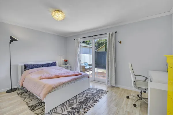 a bedroom with a bed and a dresser