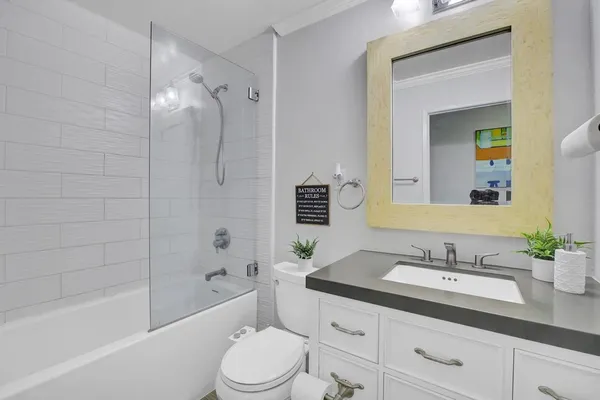 a bathroom with a sink a toilet and mirror