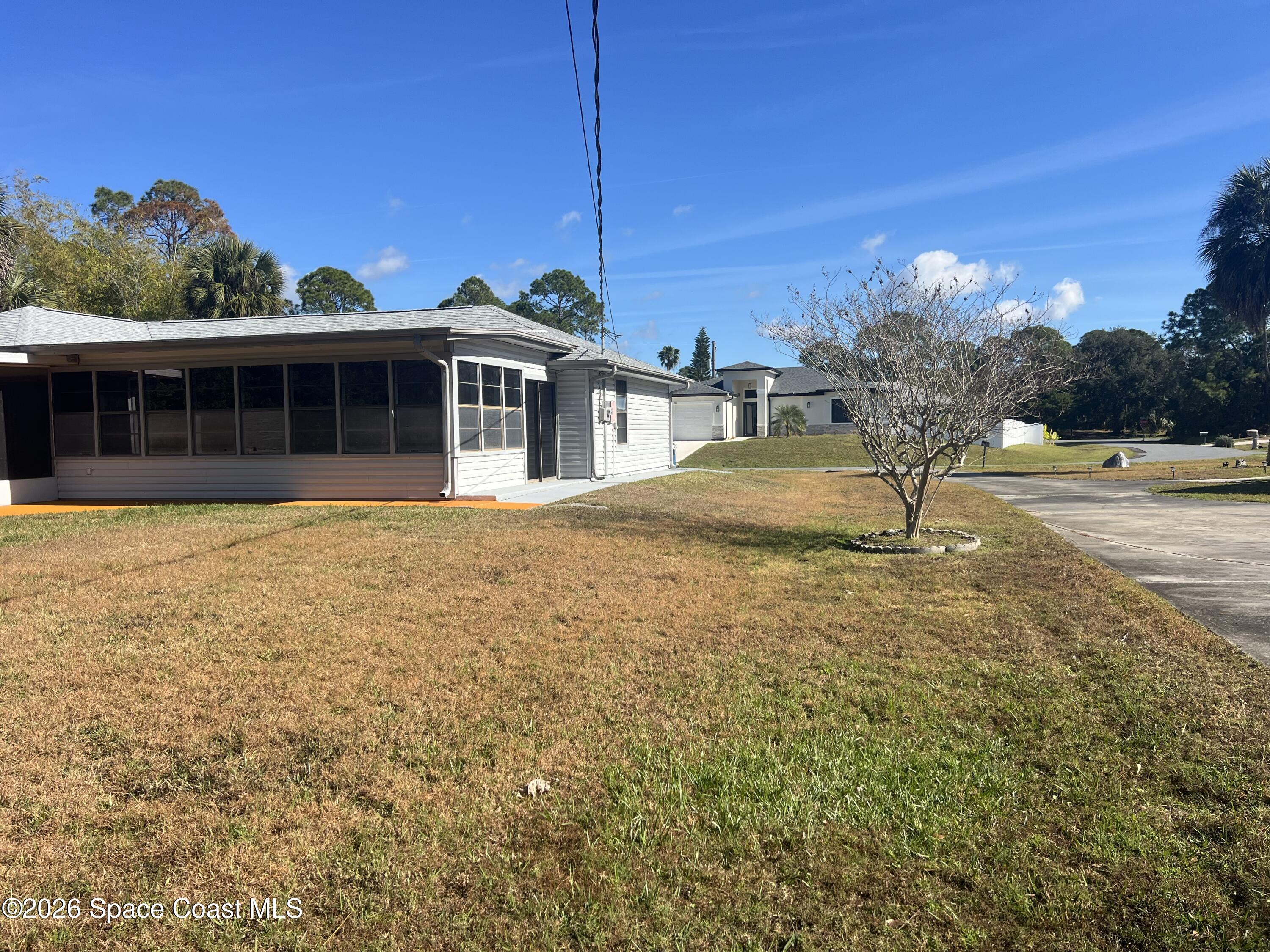 1766 Sand Road Southeast Palm Bay, FL 32909 - Photo 11 of 13 a view of a house with a yard