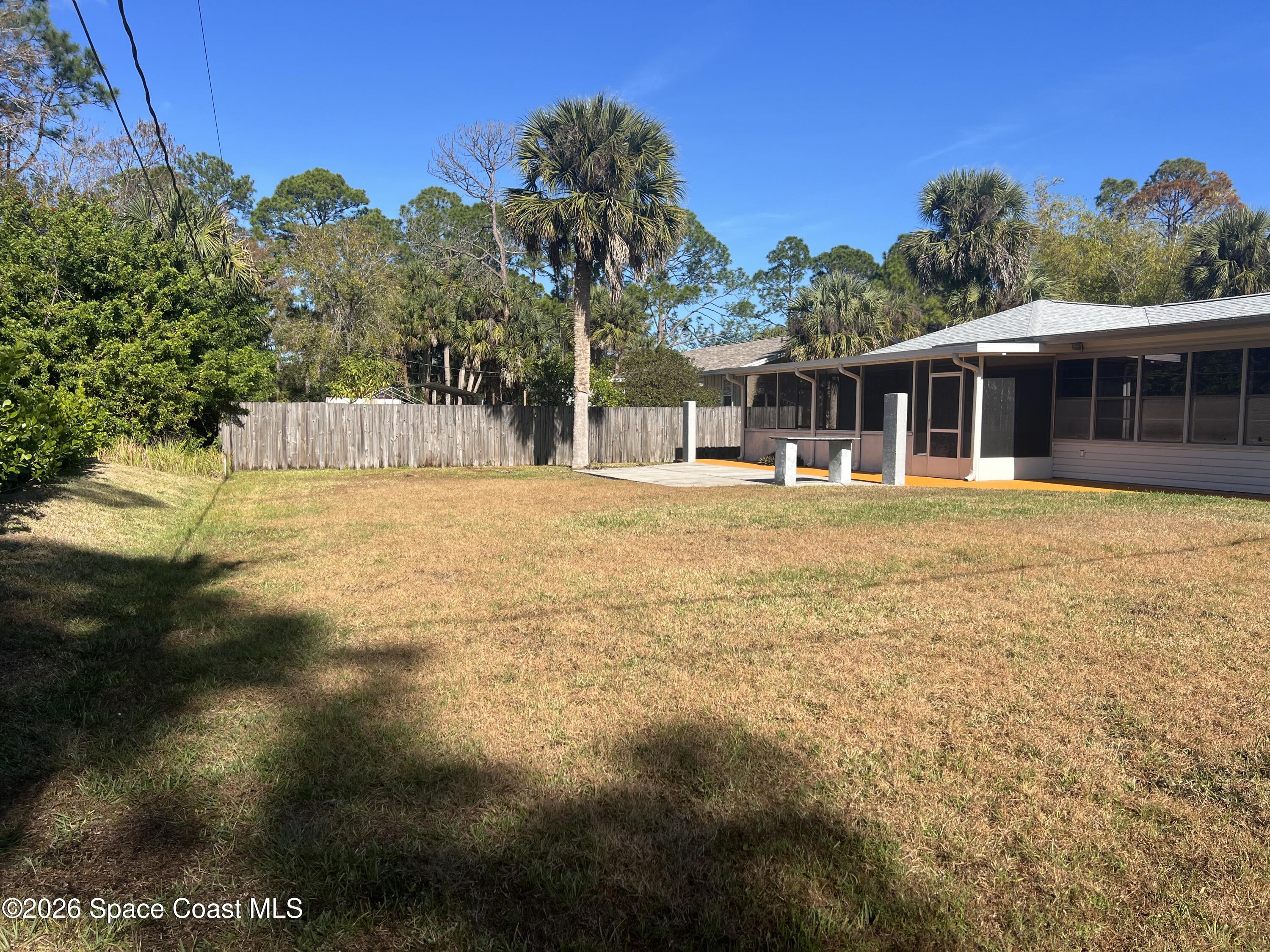 1766 Sand Road Southeast Palm Bay, FL 32909 - Photo 12 of 13 a front view of a house with a yard