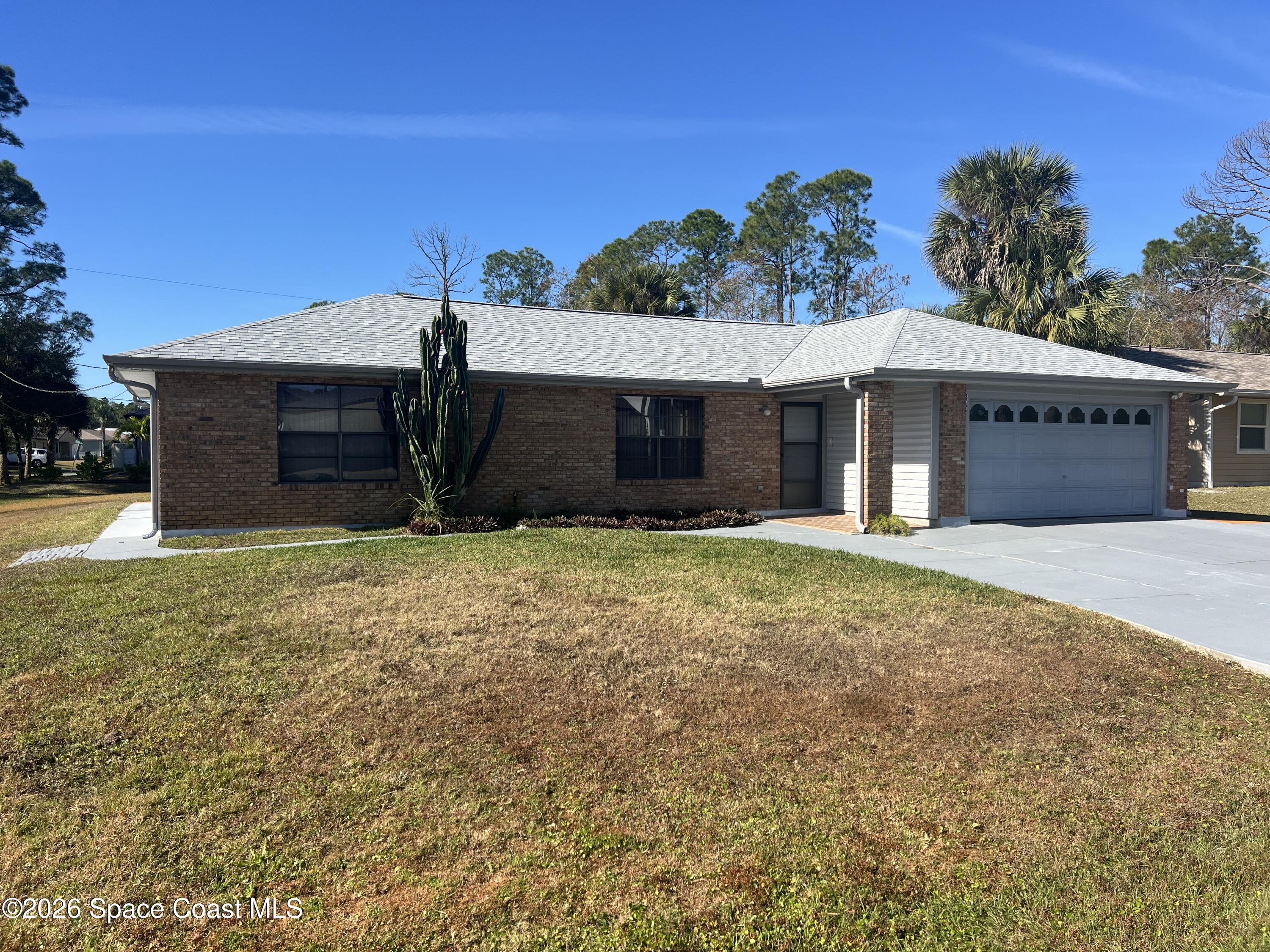 1766 Sand Road Southeast Palm Bay, FL 32909 - Photo 2 of 13 a view of a house with a yard