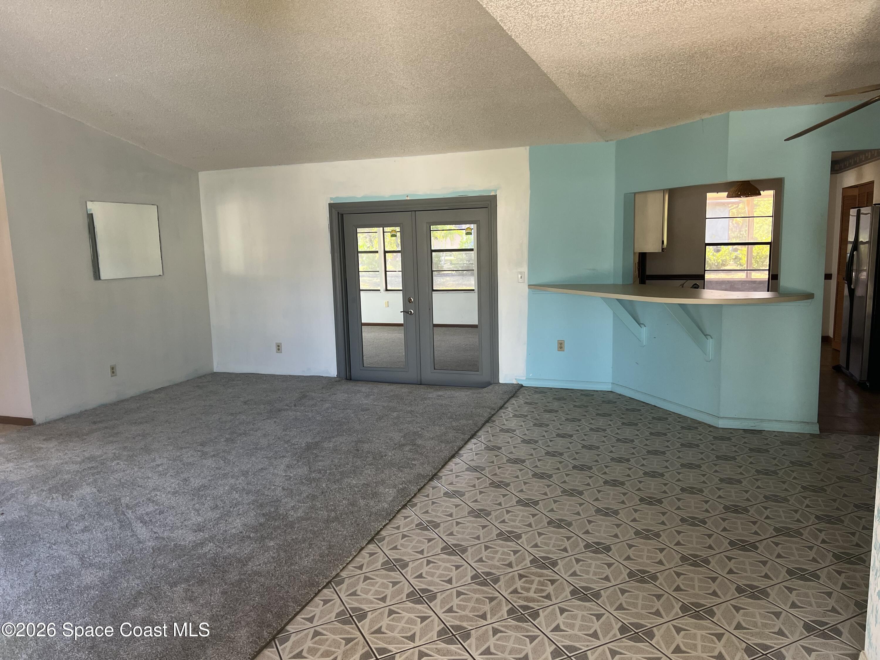 1766 Sand Road Southeast Palm Bay, FL 32909 - Photo 3 of 13 a view of a big room with windows and fireplace