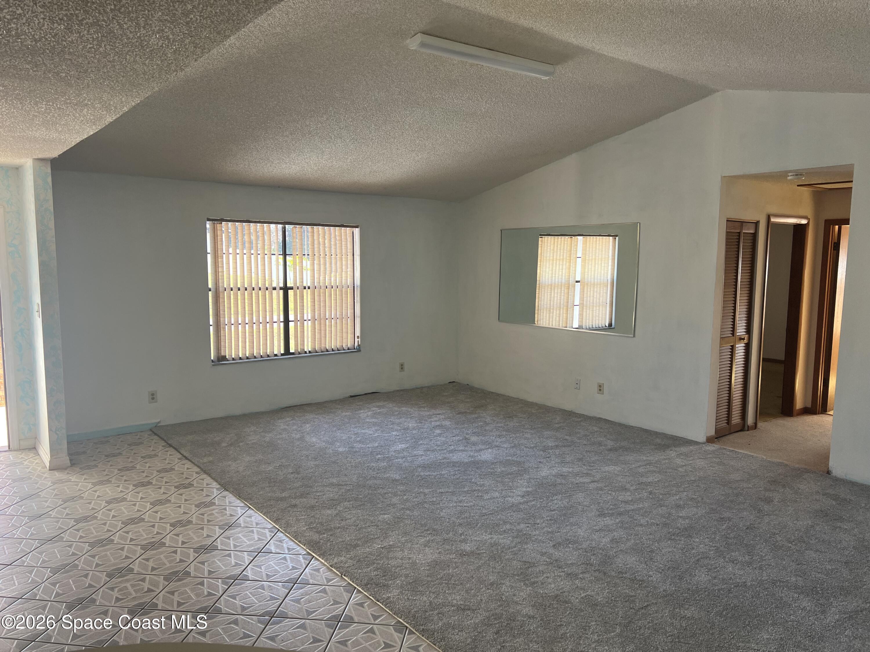 1766 Sand Road Southeast Palm Bay, FL 32909 - Photo 6 of 13 an empty room with windows
